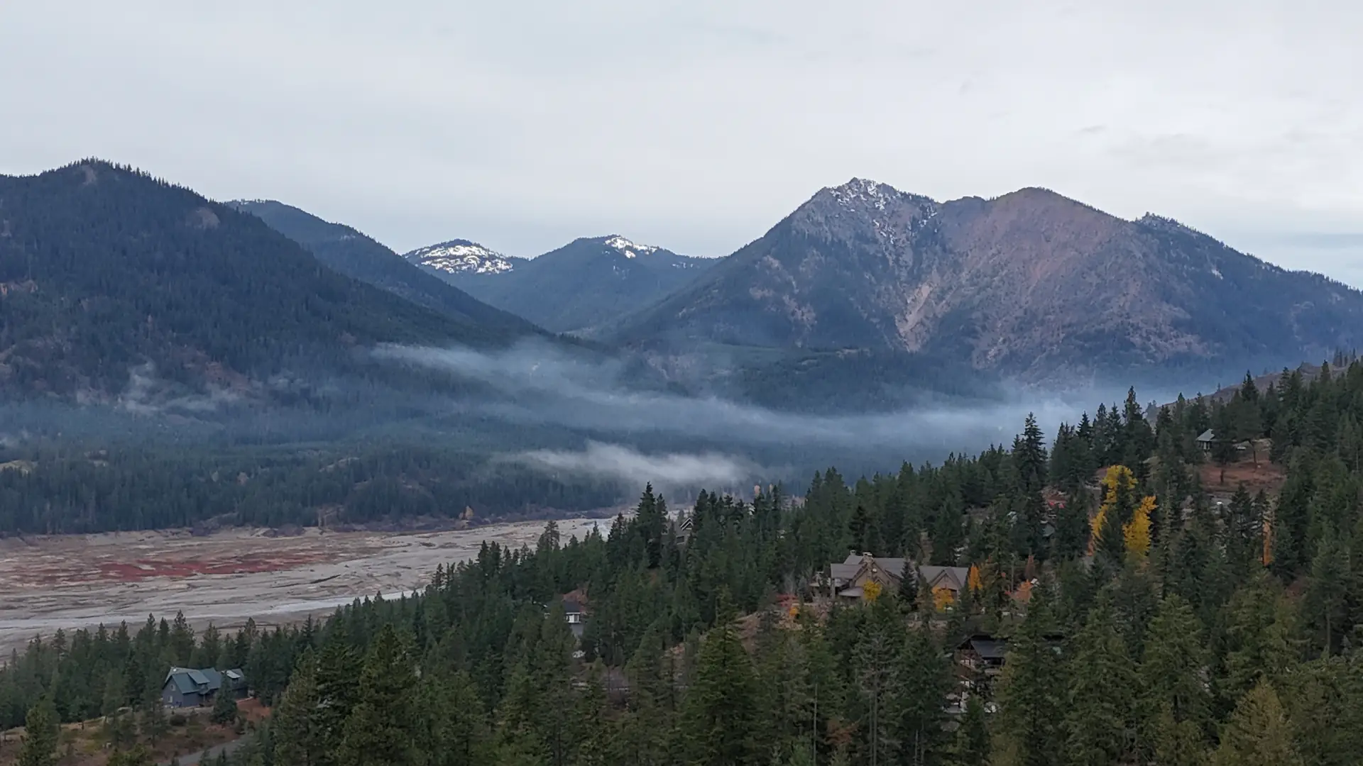 Lake Cle Elum and snow-dusted mountains above forested hillsides
