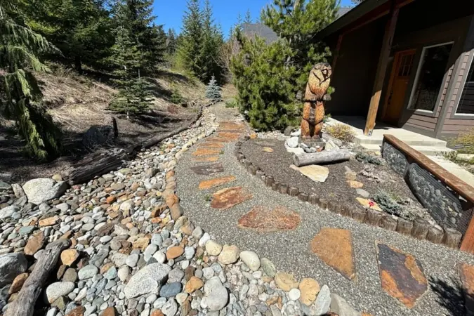 River rock and flagstone walkway leading to a cabin door