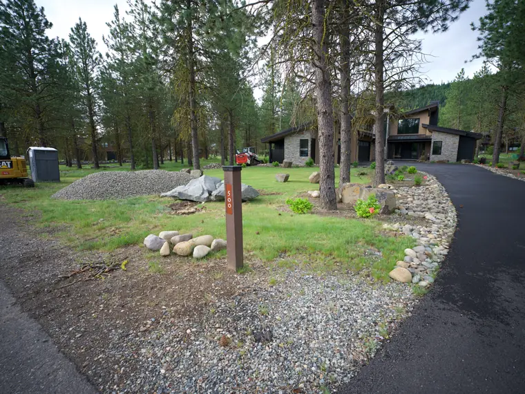 During the build: rock-edged drainage along the curve of the driveway