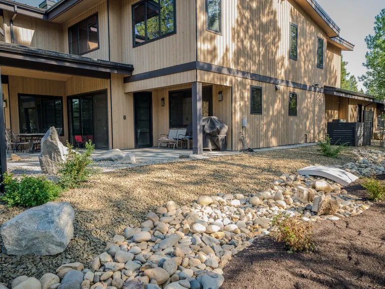 Dry creek and footbridge beside the back patio